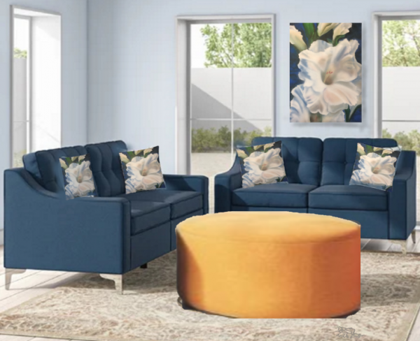 two blue couches displaying 4 painted white gladiola pillows and white gladiola painting on wall